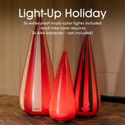 Three LED tree cones with colorful lighting on a wooden floor.